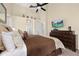 Relaxing main bedroom with a dark wood bed frame, decorative pillows, and natural light creates a serene atmosphere at 3125 Samosa Hill Cir, Clermont, FL 34714