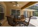 Covered patio with ceiling fan, sliding doors, and comfortable seating area, perfect for outdoor entertaining at 3125 Samosa Hill Cir, Clermont, FL 34714