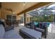 A screened-in patio with comfortable seating and views of the pool at 3125 Samosa Hill Cir, Clermont, FL 34714
