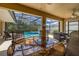 Inviting screened-in patio overlooking the pool and garden, ideal for relaxation and enjoying the outdoors at 3125 Samosa Hill Cir, Clermont, FL 34714