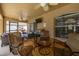 A full outdoor setup on the patio: grill, television, fan, and comfortable seating surrounding the table at 3125 Samosa Hill Cir, Clermont, FL 34714