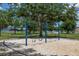 Swinging area in the playground with blue frame and sand base, surrounded by lush greenery at 3125 Samosa Hill Cir, Clermont, FL 34714