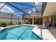 Inviting screened-in pool area with lounge chairs and covered patio at 3125 Samosa Hill Cir, Clermont, FL 34714