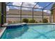 Sparkling screened-in pool and spa area with lounge chairs at 3125 Samosa Hill Cir, Clermont, FL 34714