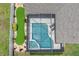 Aerial view of backyard screened pool and putting green surrounded by lush greenery at 3125 Samosa Hill Cir, Clermont, FL 34714