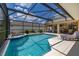 Inviting pool with spa and sun-lounging area under a screened enclosure at 3125 Samosa Hill Cir, Clermont, FL 34714