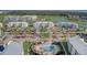 Aerial view of community featuring a pool, palm trees, manicured landscaping, and ample parking at 3150 Paradox Cir # 104, Kissimmee, FL 34746