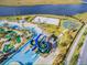Aerial view of community including water slides, mini golf, volleyball court, and basketball court at 3150 Paradox Cir # 104, Kissimmee, FL 34746