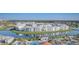 Aerial view of a community with a lake surrounded by new condominium buildings at 3150 Paradox Cir # 104, Kissimmee, FL 34746