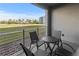 Balcony with patio seating set overlooking well-maintained lawn and landscaping at 3150 Paradox Cir # 104, Kissimmee, FL 34746