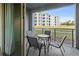 Balcony with a table and four chairs overlooking the exterior of the community at 3150 Paradox Cir # 104, Kissimmee, FL 34746