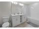Well-lit bathroom featuring double vanity with modern fixtures, a toilet, and a shower/tub combination at 3150 Paradox Cir # 104, Kissimmee, FL 34746