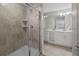 A bathroom showcasing a glass enclosed shower and double vanity with storage and tile flooring at 3150 Paradox Cir # 104, Kissimmee, FL 34746