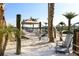 A relaxed beach area with hammocks, chairs, and a covered cabana creates a vacation atmosphere at 3150 Paradox Cir # 104, Kissimmee, FL 34746