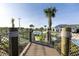 Scenic view of community amenities including pools, lush greenery, and palm trees from a bridge at 3150 Paradox Cir # 104, Kissimmee, FL 34746