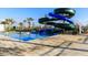 Inviting community pool with thrilling water slide and ample space for relaxation and fun at 3150 Paradox Cir # 104, Kissimmee, FL 34746