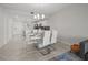 Spacious open floor plan with dining area with a modern white table and an adjacent kitchen with stainless steel appliances at 3150 Paradox Cir # 104, Kissimmee, FL 34746