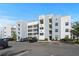 Modern multi-story condominium with grey and white exterior paint and ample parking at 3150 Paradox Cir # 104, Kissimmee, FL 34746