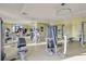 The community gym features modern fitness equipment with natural light creating an inviting workout space at 3150 Paradox Cir # 104, Kissimmee, FL 34746