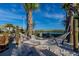 Community sand area featuring a hammock, lake view, and covered gazebo at 3150 Paradox Cir # 104, Kissimmee, FL 34746