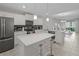 A modern kitchen with a large island and an open concept to the dining room at 3150 Paradox Cir # 104, Kissimmee, FL 34746