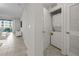 Hallway showing washer/dryer closet with door leading to outside balcony and dining area at 3150 Paradox Cir # 104, Kissimmee, FL 34746