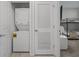 Hallway with washer/dryer unit inside closet with access to second bedroom with bunk beds and a TV at 3150 Paradox Cir # 104, Kissimmee, FL 34746