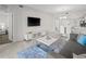 Bright living space featuring a flat-screen TV, flows into a dining area with modern white table and modern kitchen at 3150 Paradox Cir # 104, Kissimmee, FL 34746