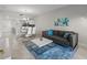 Open-concept living space flows into a dining area with seating for six, connecting seamlessly with the modern kitchen at 3150 Paradox Cir # 104, Kissimmee, FL 34746