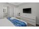A main bedroom showing a large television and access doors to a bathroom and another room at 3150 Paradox Cir # 104, Kissimmee, FL 34746