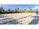 Exterior image of a sand volleyball court surrounded by greenery, perfect for outdoor activities at 3150 Paradox Cir # 104, Kissimmee, FL 34746