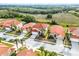 An aerial view showcases a well-maintained home featuring a red tile roof and palm tree landscaping at 321 Rosso Dr, Davenport, FL 33837