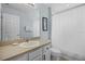 Bright bathroom features single sink vanity, framed mirror, and shower with white curtain at 321 Rosso Dr, Davenport, FL 33837