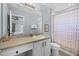 Cozy bathroom with white vanity, tile floors and patterned shower curtain at 321 Rosso Dr, Davenport, FL 33837