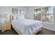Well-lit bedroom featuring a cozy bed, bedside table, and a view of palm trees at 321 Rosso Dr, Davenport, FL 33837