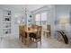 The bright and airy dining room features a chandelier, a large window, and wainscoting at 321 Rosso Dr, Davenport, FL 33837