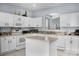 The kitchen is equipped with white cabinetry, an island, and stone backsplash at 321 Rosso Dr, Davenport, FL 33837