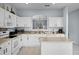 Bright kitchen features white cabinetry, stainless steel appliances, and an island with seating at 321 Rosso Dr, Davenport, FL 33837