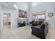 A view of the light-filled living room highlights the soaring ceilings and large windows at 321 Rosso Dr, Davenport, FL 33837