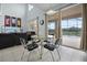 A view from the dining area toward the living room with a large slider door to the pool at 321 Rosso Dr, Davenport, FL 33837