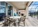 Outdoor patio with seating area, grill, and screened-in pool in the background at 321 Rosso Dr, Davenport, FL 33837