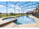 Relaxing pool area with a hot tub and a screened enclosure, offering privacy and views at 321 Rosso Dr, Davenport, FL 33837