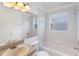 Clean bathroom with shower-tub combo and vanity with tan countertop at 3370 Cypress Point Cir, St Cloud, FL 34772