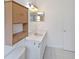 Comfortable bathroom featuring modern lighting and vanity with storage at 3370 Cypress Point Cir, St Cloud, FL 34772