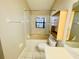 Cozy bathroom with tub, vanity, and cabinet at 3370 Cypress Point Cir, St Cloud, FL 34772