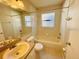 Bright bathroom with a shower-tub combo, vanity, and tile flooring at 3370 Cypress Point Cir, St Cloud, FL 34772