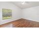 Bedroom with hardwood floors, a ceiling fan, and a bright window view at 3370 Cypress Point Cir, St Cloud, FL 34772