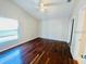 Bedroom with hardwood floors, ceiling fan, and a window for natural light at 3370 Cypress Point Cir, St Cloud, FL 34772