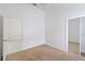 Bedroom featuring carpeted floors, neutral walls, a closet, and a doorway at 3370 Cypress Point Cir, St Cloud, FL 34772