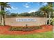 Cypress Point community entrance surrounded by palm trees and colorful landscaping at 3370 Cypress Point Cir, St Cloud, FL 34772
